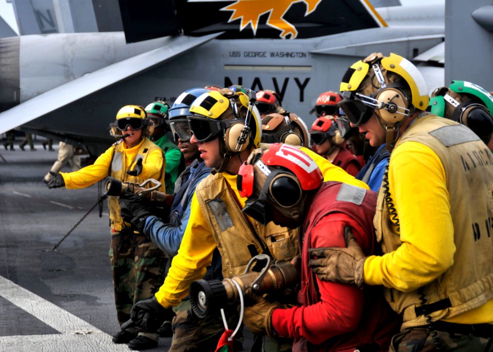 US Navy 101018-N-7103C-120 Hose team members move into position during a fire drill on the flight deck aboard the aircraft carrier USS George Washi