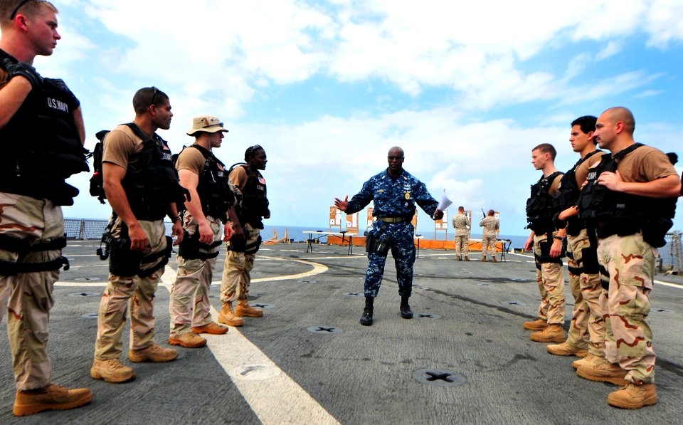 US Navy 101018-N-7948R-243 Senior Chief Master-at-Arms Robert Goode, center, gives pre-fire instructions to a visit, board, search and seizure team