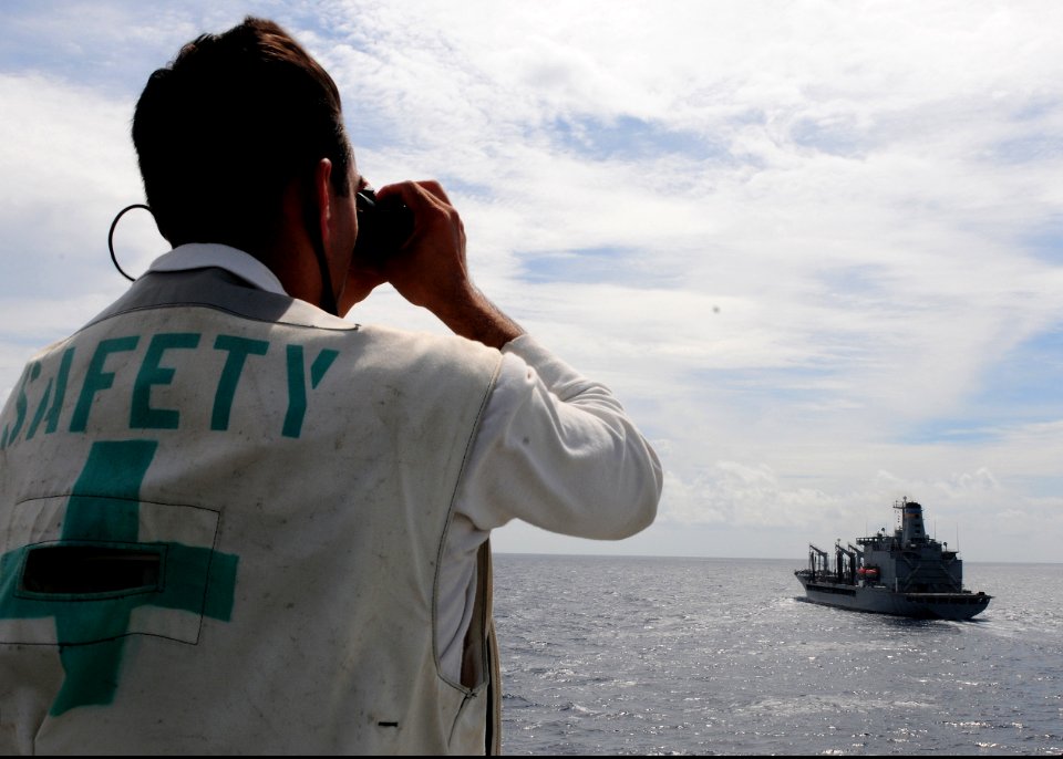 US Navy 101018-N-5538K-019 Aviation Boatswain's Mate (Handling) 1st Class Nathaniel R. Sukal uses a laser rangefinder to measure the distance to th