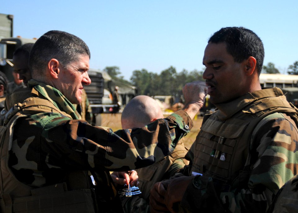 US Navy 101017-N-9564W-066 ommand chaplain Lt. Harold Woodruff, assigned to Naval Mobile Construction Battalion (NMCB) 74, gives communion during a