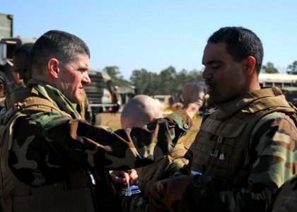 US Navy 101017-N-9564W-066 ommand chaplain Lt. Harold Woodruff, assigned to Naval Mobile Construction Battalion (NMCB) 74, gives communion during a photo