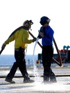 US Navy 101022-N-2686K-233 Sailors aboard the aircraft carrier USS George H.W. Bush (CVN 77) clean the flight deck
