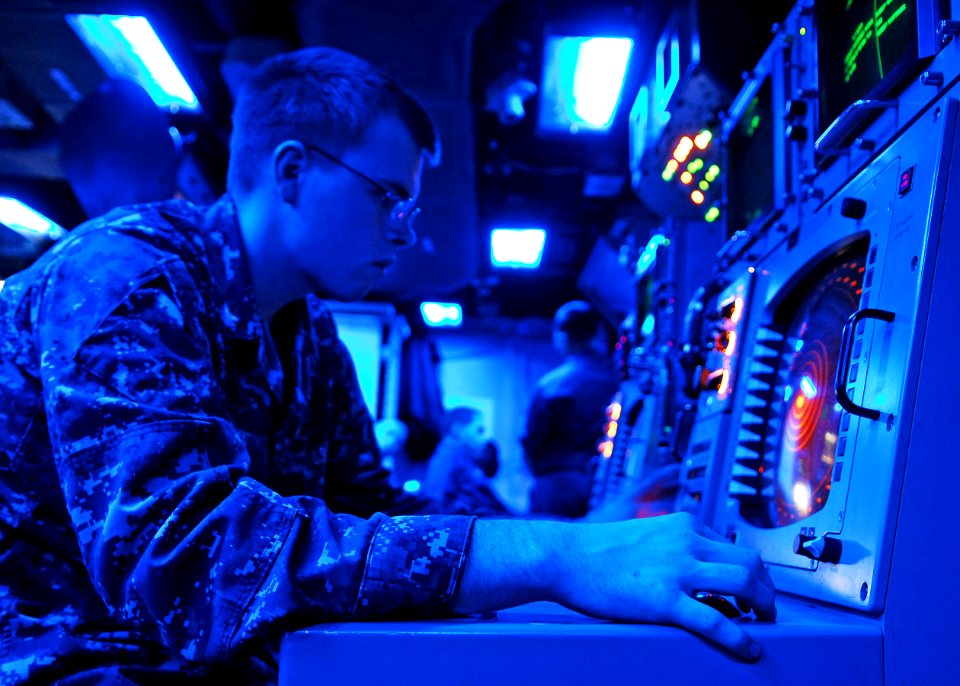 US Navy 101019-N-2218S-056 Fire Controlman 3rd Class Shane Nichlos tests a radar display in the combat information center aboard the amphibious ass