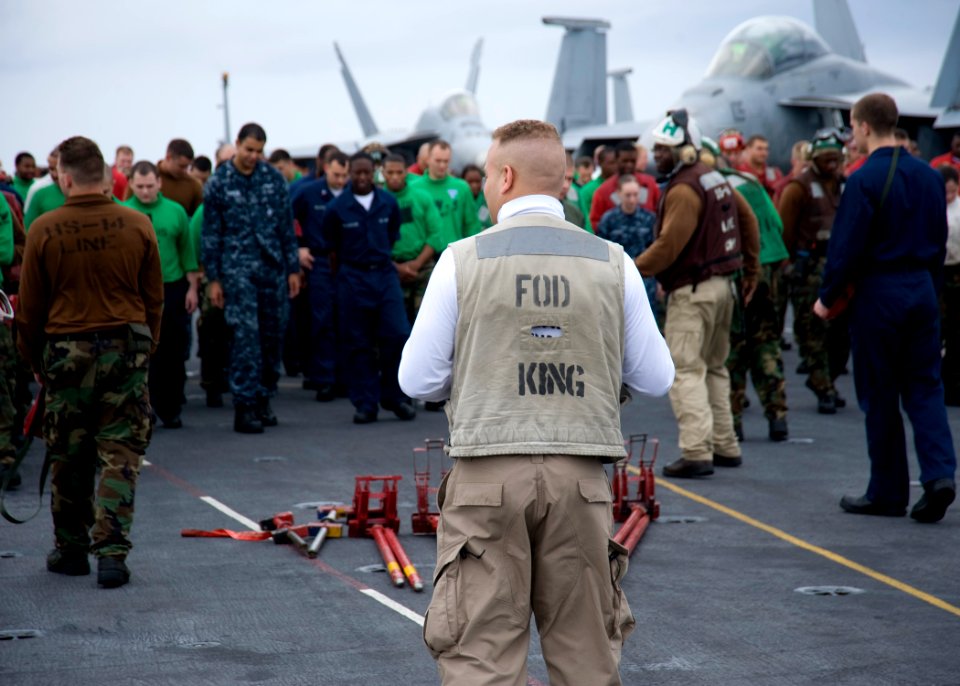 US Navy 101018-N-8721D-004 Chief Avation Ordnanceman George Machado, from Brooklyn, N.Y., prepares to collect foreign object debris (FOD) during a