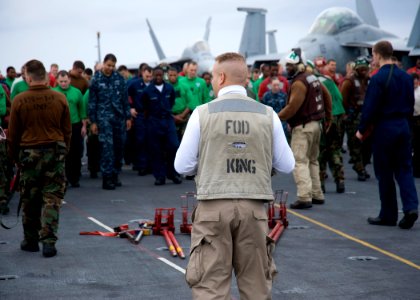 US Navy 101018-N-8721D-004 Chief Avation Ordnanceman George Machado, from Brooklyn, N.Y., prepares to collect foreign object debris (FOD) during a