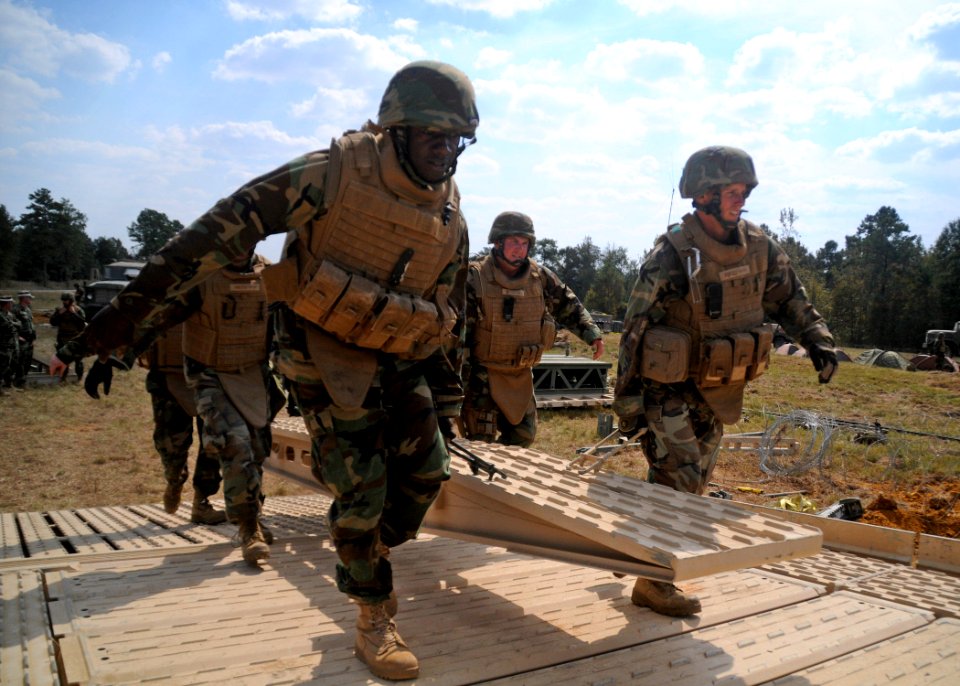 US Navy 101019-N-9564W-038 Members of the bridge detachment of Naval Mobile Construction Battalion (NMCB) 74 move a 300 pound medium girder bridge