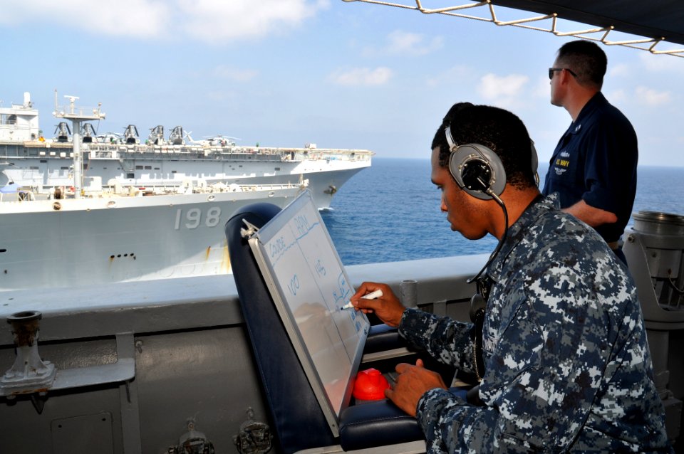 US Navy 101020-N-7293M-318 Sailors observe the positions of the Military sealift Command fleet replenishment oiler USNS Big Horn (T-AO 198) and the