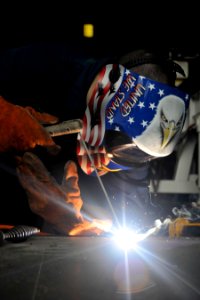 US Navy 101021-N-7103C-172 A Sailor welds a ramp on the fantail of the aircraft carrier USS George Washington (CVN 73)