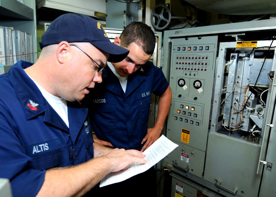 US Navy 101023-N-6632S-013 Fire Controlman 1st Class Scott M. Altis, left, and Fire Controlman 3rd Class David M. Lazcos perform pre-fire checks f