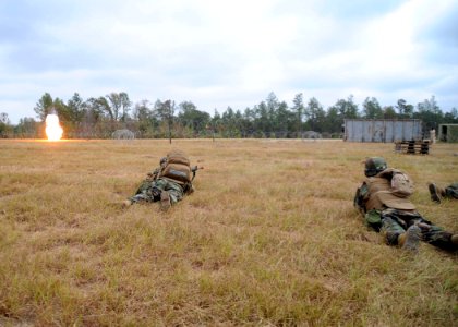 US Navy 101020-N-4440L-120 Seabees from Naval Mobile Construction Battalion (NMCB) 74 take cover from a simulated rocket grenade explosion during a photo