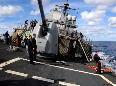 US Navy 101024-N-3885H-054 Sailors aboard the guided-missile cruiser USS Philippine Sea (CG 58) lean with the ship as it performs high-speed rudder