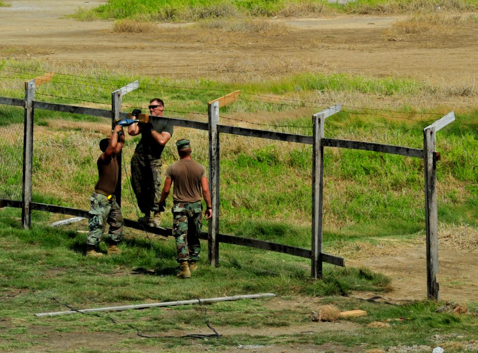 US Navy 101025-N-1531D-007 Seabees and Marines repair a fence outside the Corentyne School during a Continuing Promise 2010 engineering community s