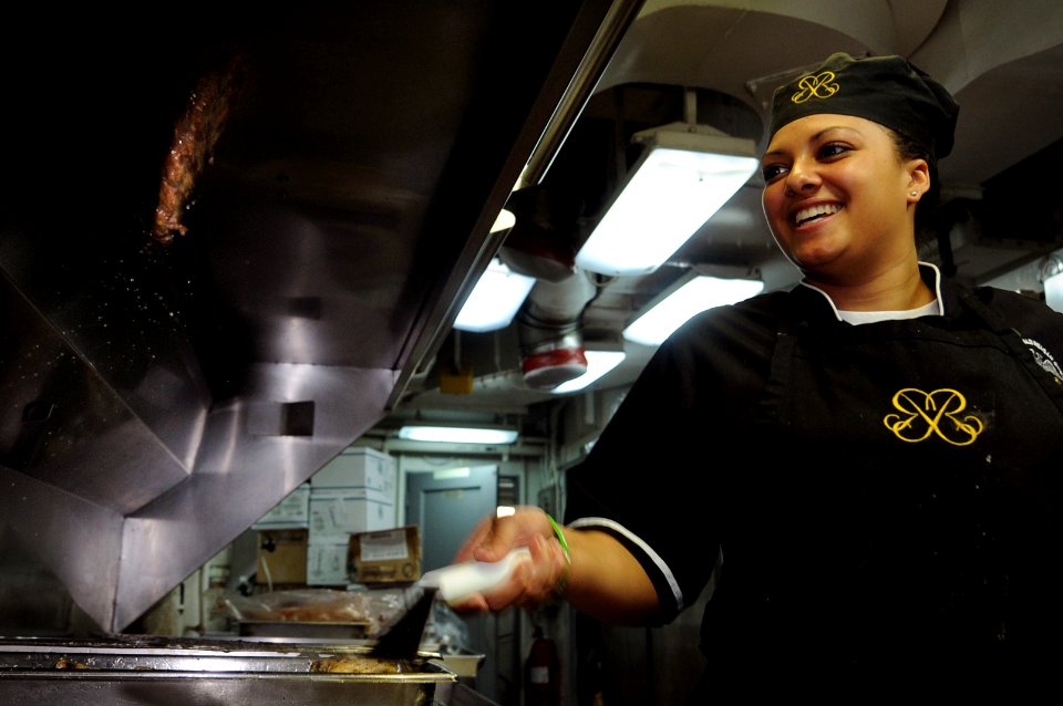 US Navy 101020-N-9132C-092 Culinary Specialist Seaman Apprentice Christina Clayton, from Atlanta, prepares hamburgers for officers in the wardroom