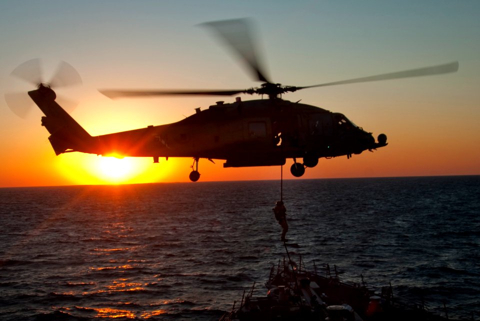 US Navy 101021-N-9589S-421 xplosive ordnance disposal team members assigned to the Enterprise Carrier Strike Group, fast-rope onto the deck of the