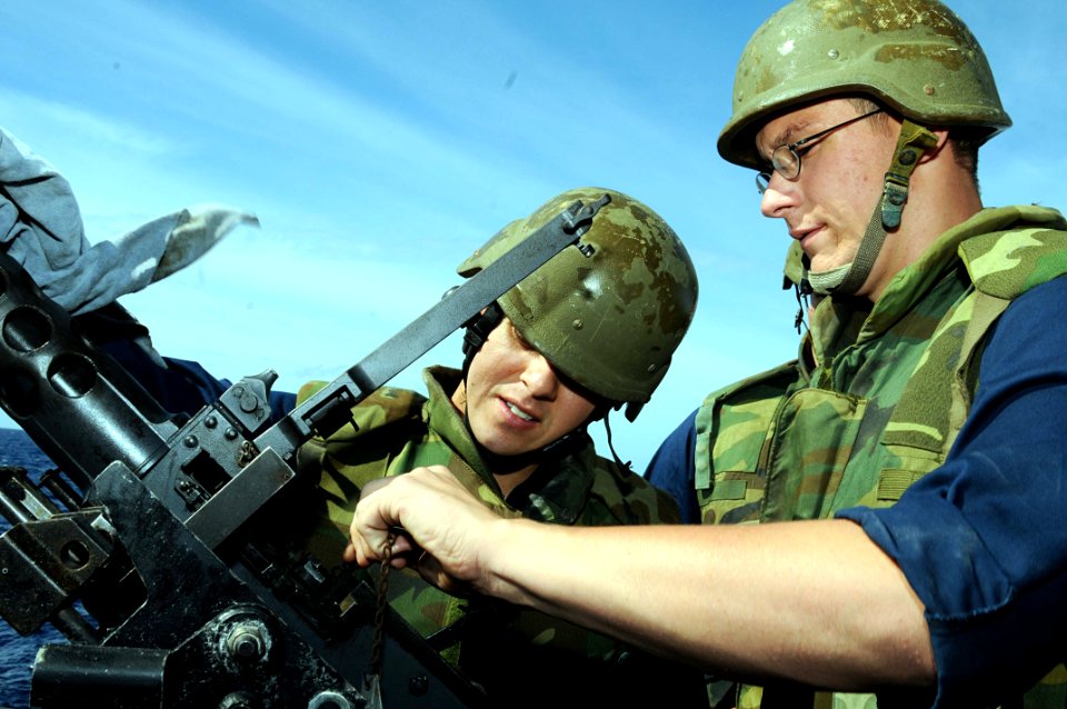 US Navy 101025-N-1854W-022 Interior Communications Electrician 2nd Class Neil Hodges and Logistics Specialist 2nd Class James prepare a .50-caliber