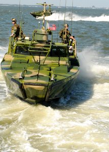 US Navy 101021-N-5085J-170 Sailors assigned to Riverine Group 1 conduct maneuvers aboard Riverine Command Boat (Experimental) (RCB-X) at Naval Stat