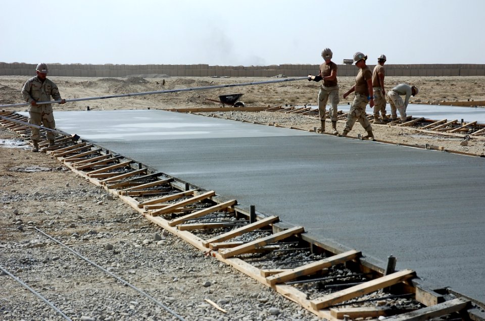US Navy 101022-N-6436W-014 eabees assigned to Naval Mobile Construction Battalion (NMCB) 40 place concrete for a project site