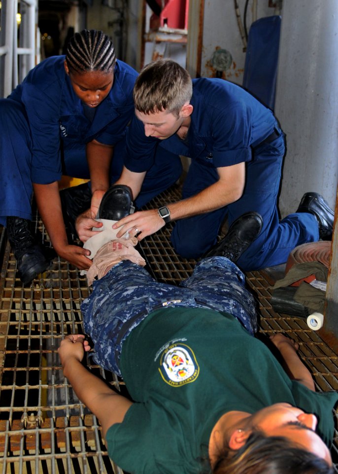 US Navy 101025-N-8069G-111 Culinary Specialist Seaman Apprentice Charrdonay Smith and Hospitalman Justin Milam practice bandaging techniques on Boa