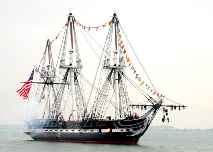 US Navy 101021-N-7642M-164 USS Constitution fires a 21-gun salute toward Fort Independence on Castle Island during an underway to celebrate the 213