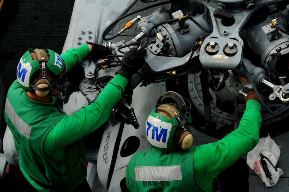 US Navy 101025-N-8560K-065 Sailors assigned to Helicopter Maritime Attack Squadron (HSM) 70 perform maintenance on an MH-60R Sea Hawk helicopter ab