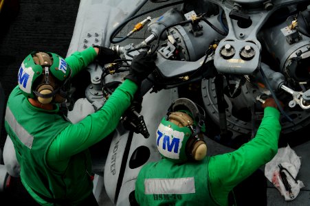 US Navy 101025-N-8560K-065 Sailors assigned to Helicopter Maritime Attack Squadron (HSM) 70 perform maintenance on an MH-60R Sea Hawk helicopter ab
