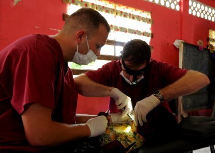 US Navy 101023-N-7680E-068 Hospital Corpsman 2nd Class Anthony Tevere, left, and Canadian Army Capt. Peter Walker, both embarked aboard the multi-p