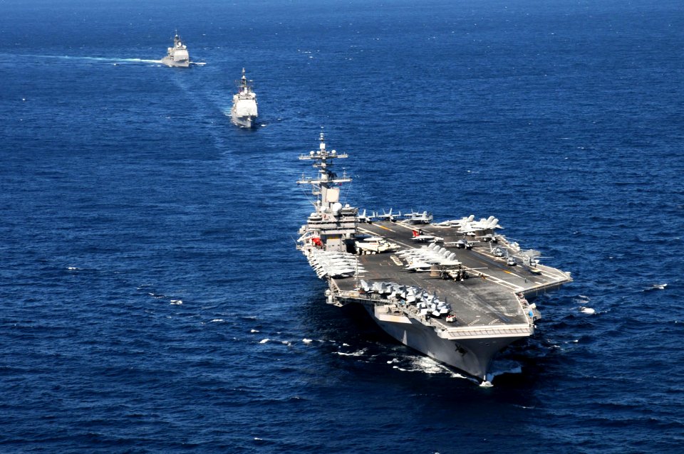 US Navy 101022-N-4154B-223 The aircraft carrier USS George H.W. Bush (CVN 77), front, and the guided-missile cruisers USS Philippine Sea (CG 58) an