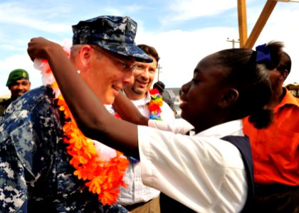 US Navy 101026-N-1531D-230 Capt. Thomas Negus, commodore of Continuing Promise 2010, receives a lay from a girl during a ceremony closing the Guyan