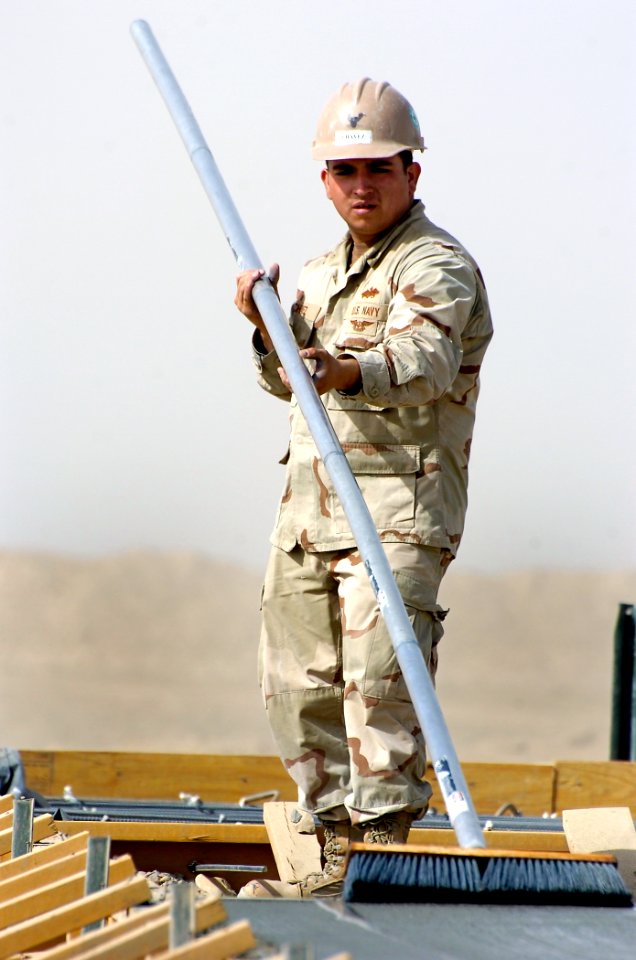 US Navy 101022-N-6436W-039 Builder Constructionman Jacob Chavez, assigned to Naval Mobile Construction Battalion (NMCB) 40, places concrete for a p