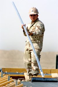 US Navy 101022-N-6436W-039 Builder Constructionman Jacob Chavez, assigned to Naval Mobile Construction Battalion (NMCB) 40, places concrete for a p
