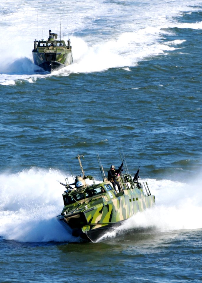 US Navy 101022-N-9565D-190 Sailors assigned to Riverine Group 1 stand their post aboard Riverine Command Boat (Experimental) (RCB-X)