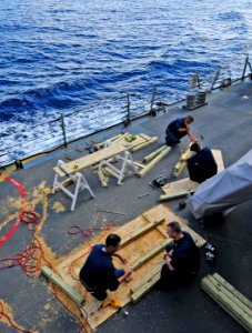 US Navy 101024-N-8913A-100 Sailors create wood shooting targets on the weather deck aboard the guided-missile destroyer USS Mitscher (DDG 57)
