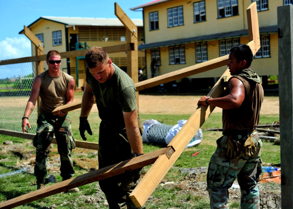 US Navy 101025-N-1531D-234 Seabees and Marines repair a fence outside the Corentyne School during a Continuing Promise 2010 engineering community s