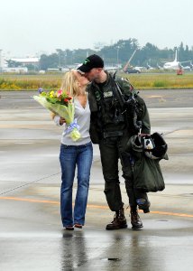US Navy 101026-N-2858S-266 Lt. Nick Hampton, assigned to the Dambusters of Strike Fighter Squadron (VFA) 195, kisses his wife on the airfield at Na