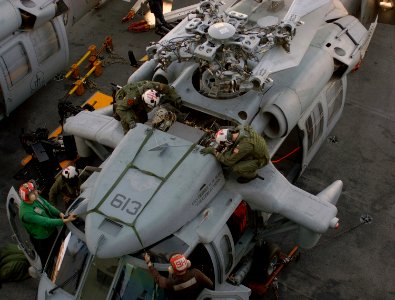 US Navy 101023-N-2686K-628 Sailors aboard the aircraft carrier USS George H.W. Bush (CVN 77) perform preflight inspections on an MH-60S Sea Hawk photo