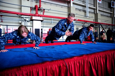 US Navy 101026-N-7526R-243 Master Chief Petty Officer of the Navy (MCPON) Rick D. West does a clapping push-up during an all-hands call at Naval Ai photo
