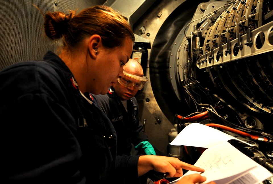 US Navy 101023-N-6632S-146 Gas Turbine System Technicians (Mechanical) 2nd Class Amanda L. Black, left, and Samuel E. Williams perform maintenance