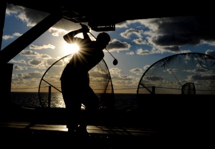 US Navy 101024-N-3737T-103 A Sailor aboard the aircraft carrier USS George H.W. Bush (CVN 77) hits a golf ball in the ship's hangar bay during a mo