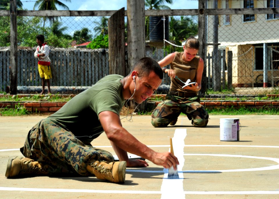 US Navy 101025-N-1531D-053 Service members paint lines for a new basketball court during a Continuing Promise 2010 engineering community service ev