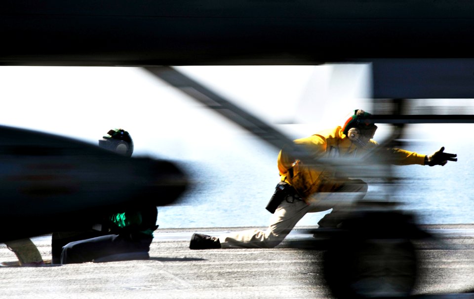 US Navy 101023-N-6003P-140 Lt. Michael Grimmett, a flight deck Shooter, launches an F-A-18E Super Hornet from the aircraft carrier USS Harry S. Tru
