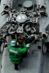 US Navy 101025-N-8560K-047 A Sailor assigned to Helicopter Maritime Attack Squadron (HSM) 70 performs maintenance on an MH-60R Sea Hawk helicopter