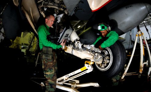 US Navy 101023-N-7103C-088 Aviation Electrician's Mate 2nd Class James Wallace, left, from Apple Valley, Calif., and Aviation Electrician's Mate A