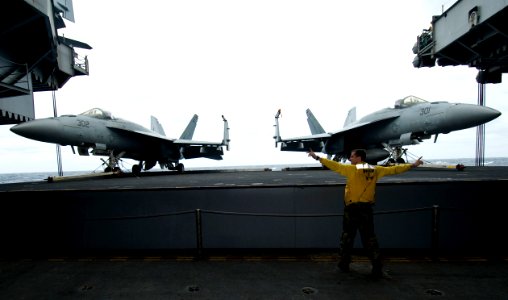 US Navy 101027-N-8721D-103 Aviation Boatswain's Mate (Handling) Airman Joshua Bray, from St. Michael, Minn., serves as a safety operator and signa