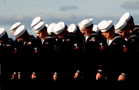 US Navy 101024-N-8913A-006 Sailors bow their heads in prayer during a burial at sea aboard the guided-missile destroyer USS Mitscher (DDG 57) photo