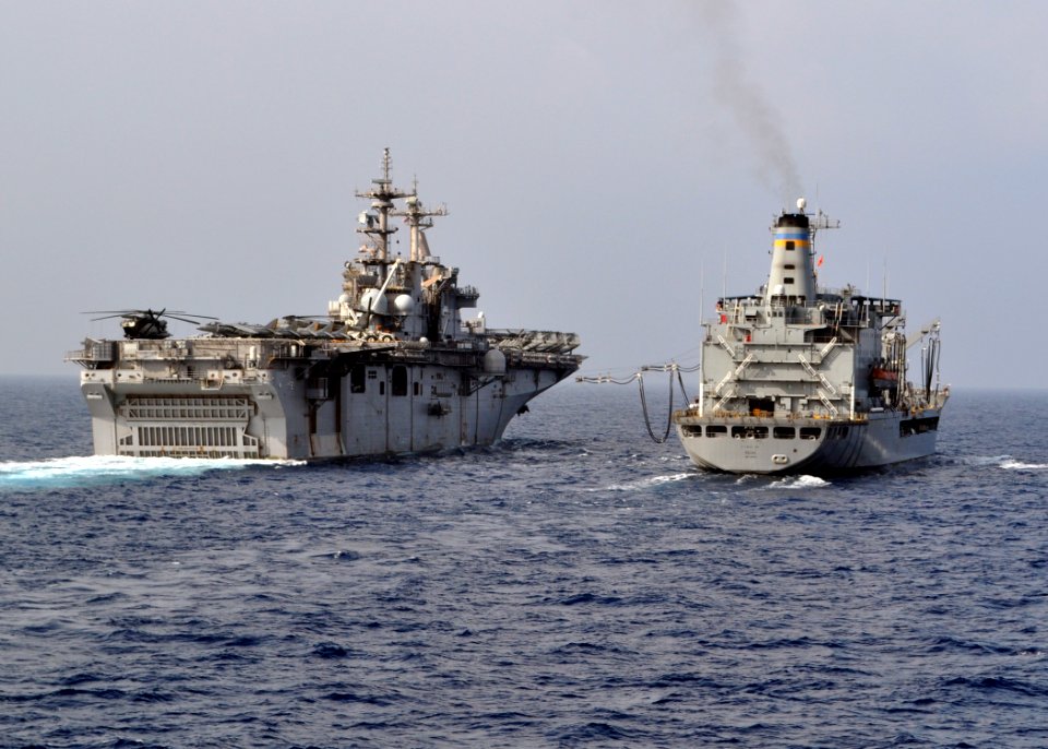 US Navy 101027-N-3620B-004 The Military Sealift Command fleet replenishment oiler USNS Pecos (T-AO 197), right, sends a fuel probe to the Wasp-clas