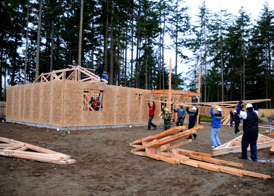 US Navy 101027-N-9520G-001 Sailors assigned to base security at Naval Air Station Whidbey Island lift roof trusses during a Habitat for Humanity bu