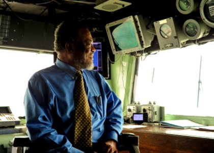 US Navy 101026-N-1531D-021 The Prime Minister of Guyana Samuel Hinds sits in the captain's chair in the bridge aboard the multi-purpose amphibious