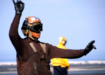 US Navy 101028-N-4973M-066 Aviation Structural Mechanic Airman Eric Cudal, from San Francisco, signals the engine start of an E-2C Hawkeye