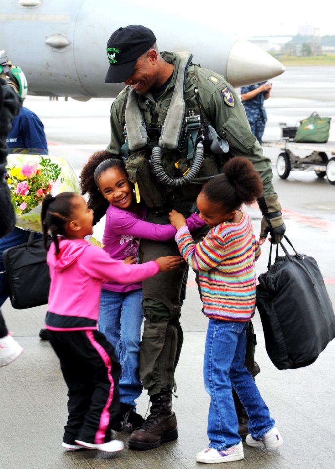 US Navy 101026-N-2858S-122 Lt. Cmdr. Victor Glover, assigned to the Dambusters of Strike Fighter Squadron (VFA) 195, is greeted by his daughters at