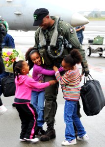 US Navy 101026-N-2858S-122 Lt. Cmdr. Victor Glover, assigned to the Dambusters of Strike Fighter Squadron (VFA) 195, is greeted by his daughters at